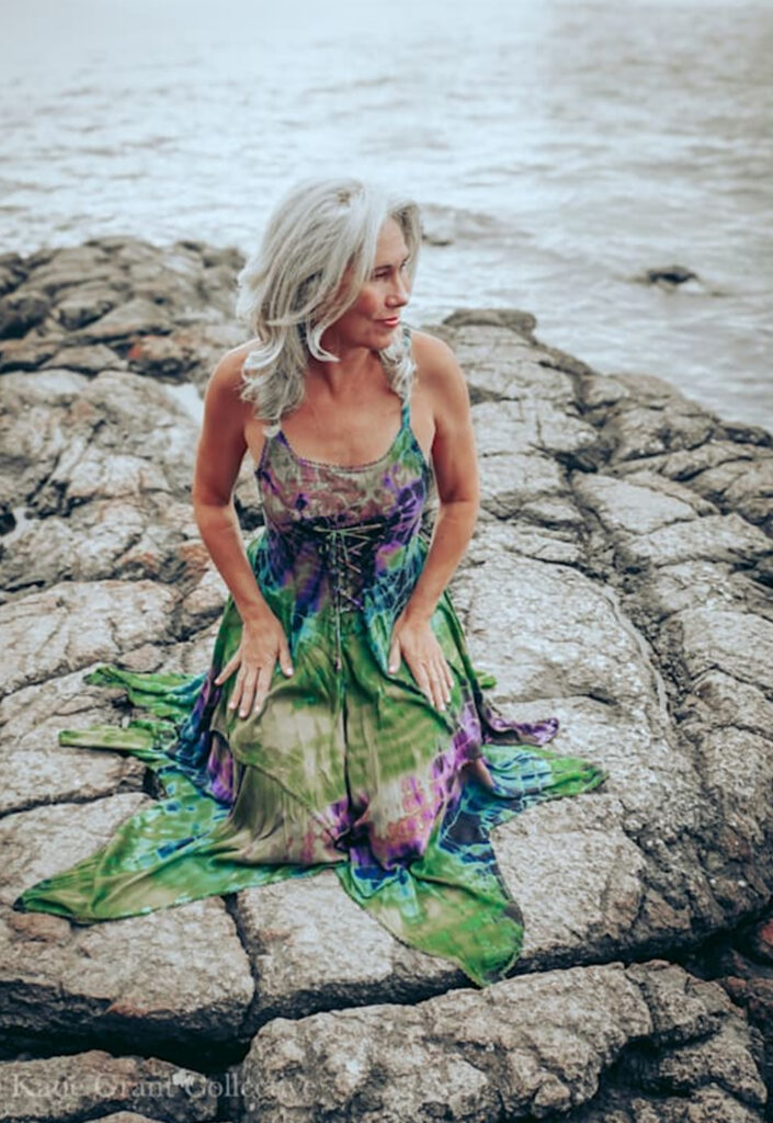 a woman sitting on a rock